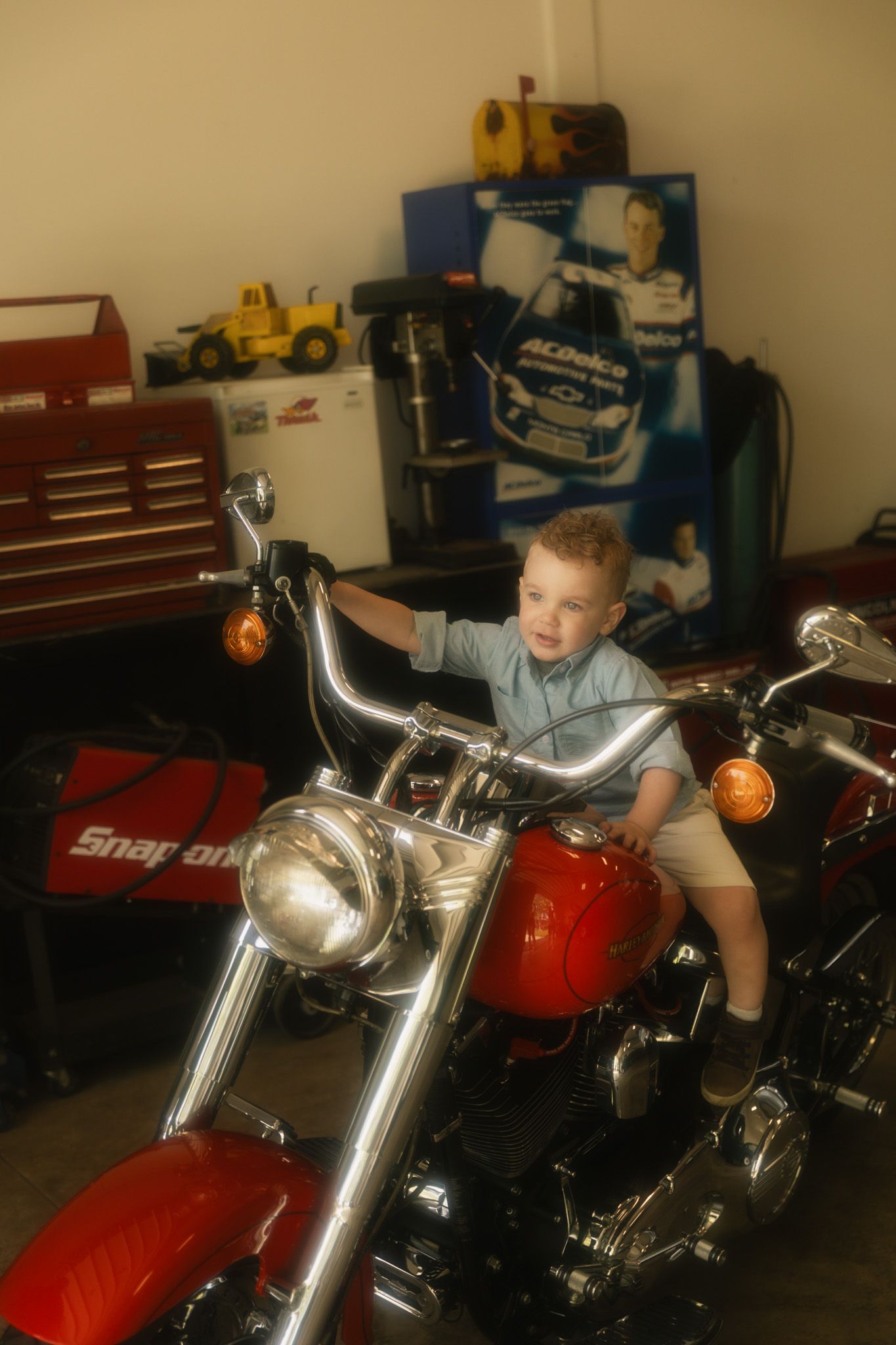 A red motorcycle on display in what appears to be a garage or showroom setting.