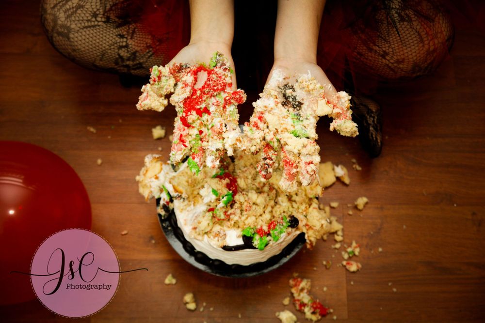 Artistic food photography featuring scattered popcorn on dark wooden surface.