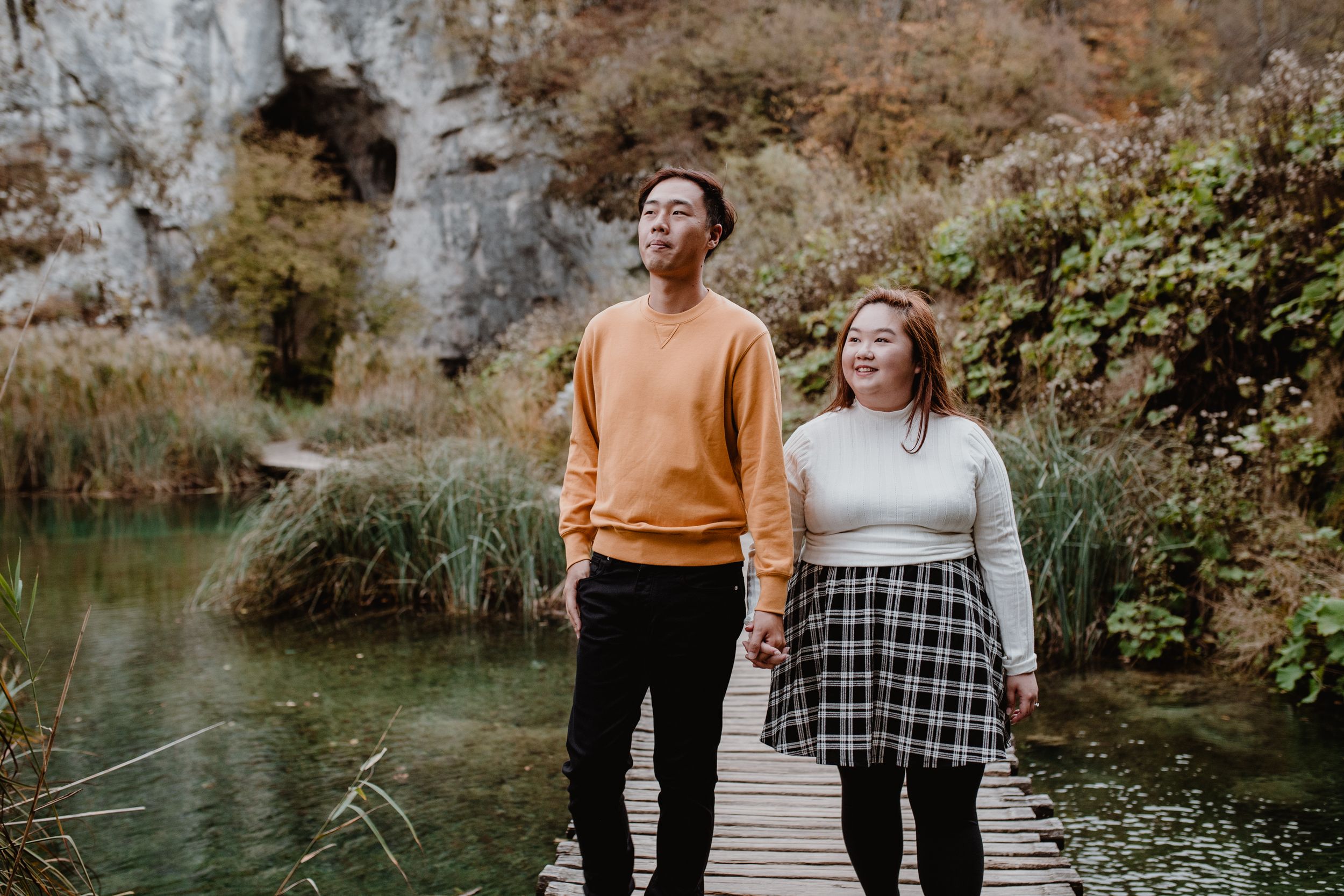 Portrait of the couple exploring Plitvice National Park in autumn, showcasing their adventurous spirit.