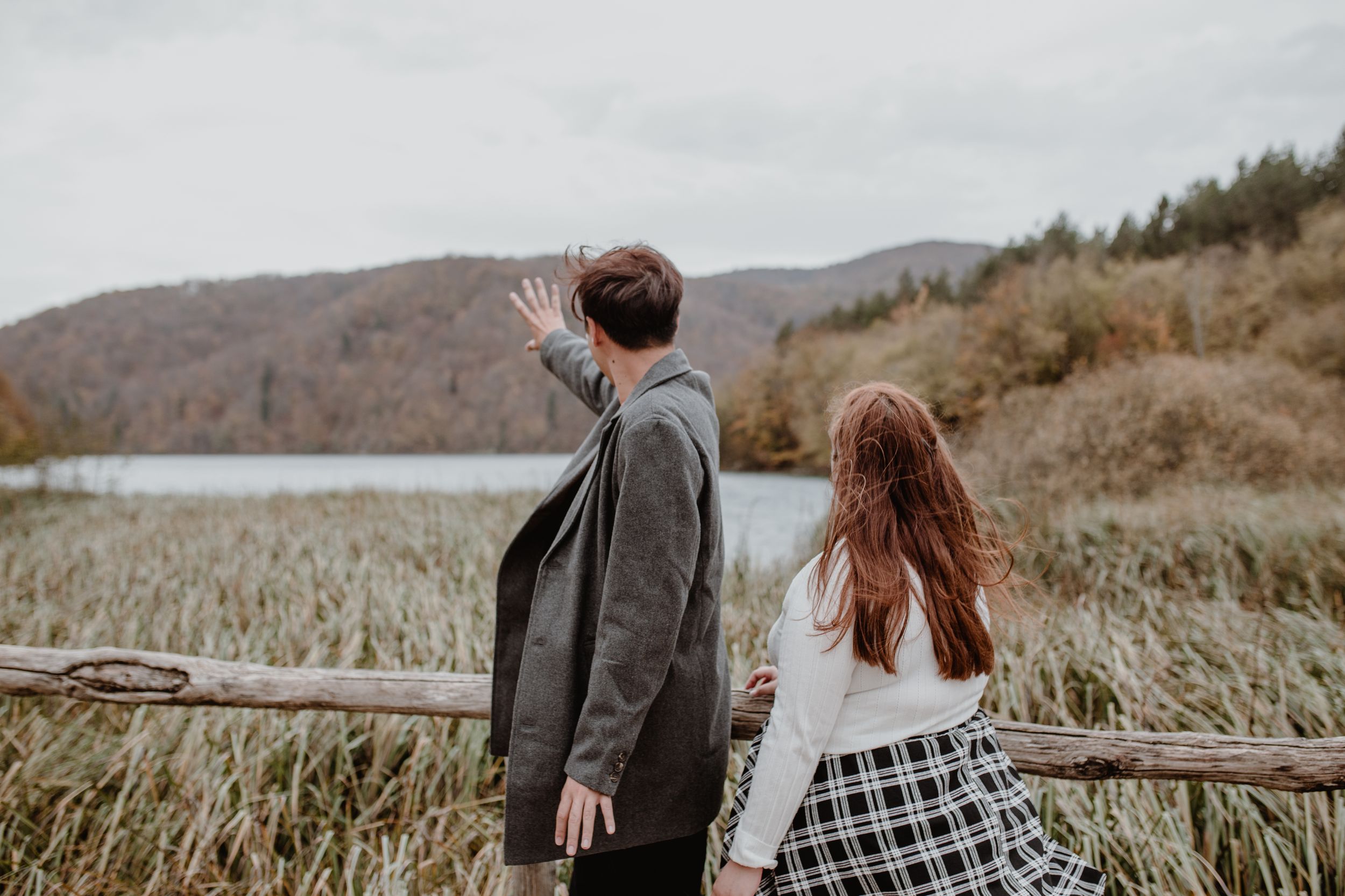 Couple enjoying a vacation photoshoot at sunrise in Plitvice Lakes National Park in Croatia.