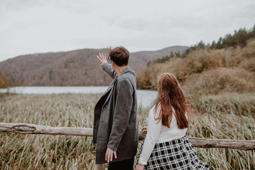 Couple enjoying a vacation photoshoot at sunrise in Plitvice Lakes National Park in Croatia.