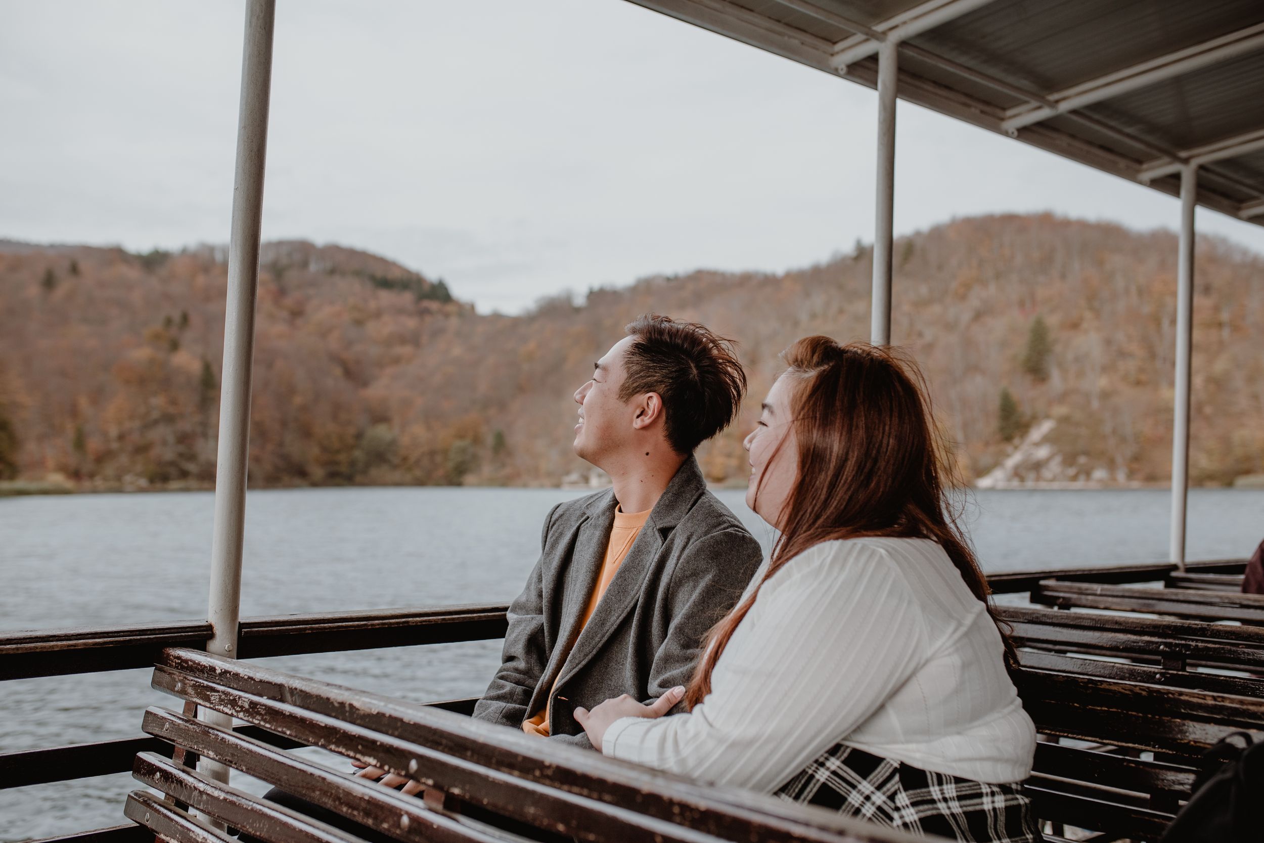 Photo of the couple enjoying a scenic boat ride at Plitvice National Park, taking in the breathtaking views.