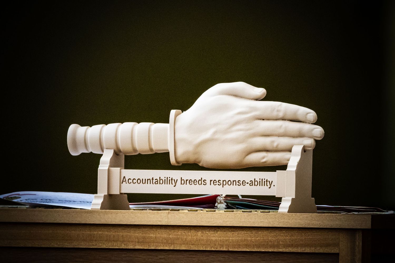Detail photo of a custom military desk trophy of a sculpted 'Knife Hand' and the leadership quote: 'Accountability breeds response-ability'