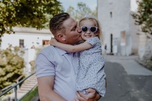 Father kissing his child’s cheek while the family explores Upper Town, Zagreb.