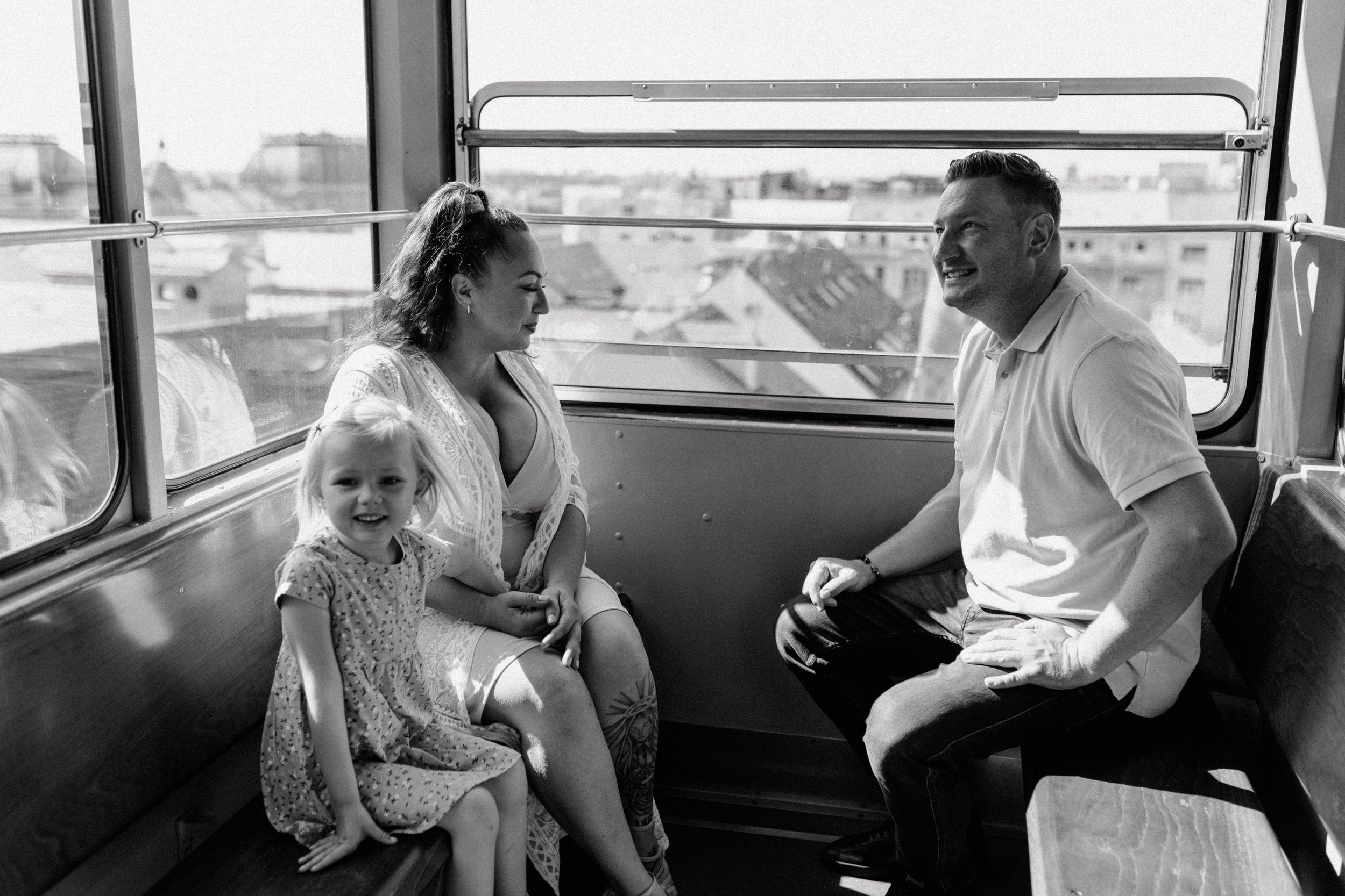 Family enjoying the funicular ride in Zagreb, smiling as they look out over the city during their vacation photoshoot.