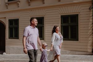 Family walking together in Upper Town, with the child leading while holding hands, capturing a genuine moment.