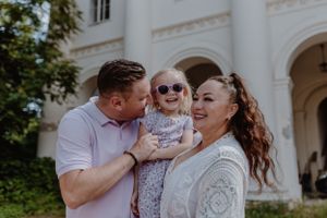 Close-up of parents embracing their child, capturing a genuine family moment in Upper Town, Zagreb.