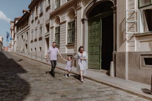 Family walking hand in hand through the streets of Upper Town, Zagreb during their vacation family photoshoot.
