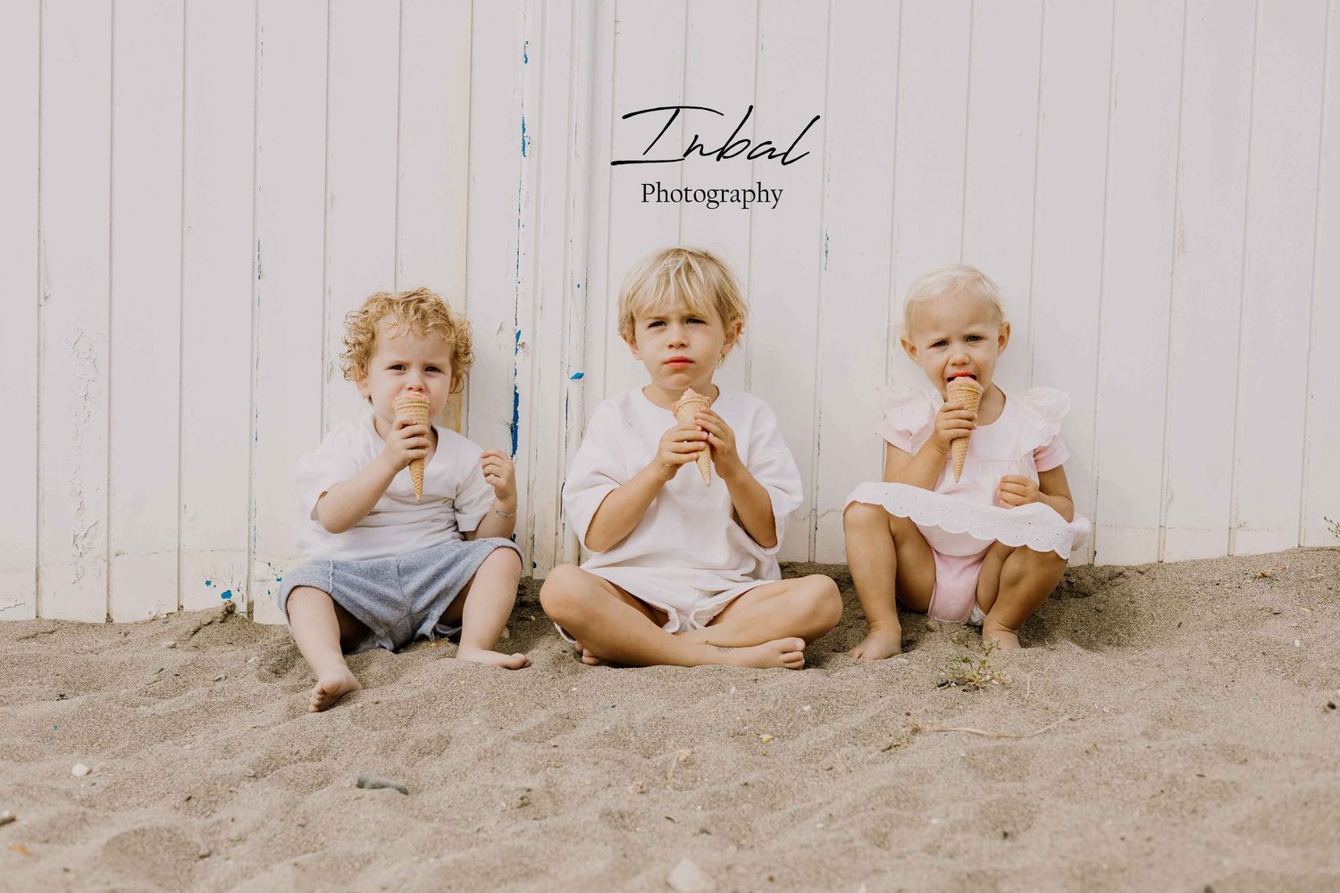 Child having so much fun throwing stones at a family photoshoot in Marbella
