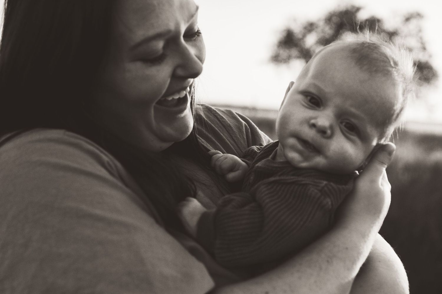 Mother brushing toddler’s hair during tender motherhood moment in Edmond
