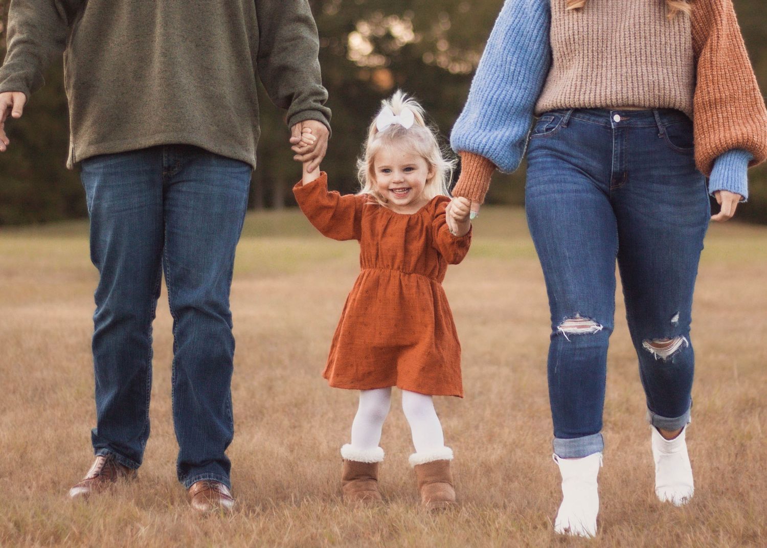 Family photos with three kids running through field in Yukon