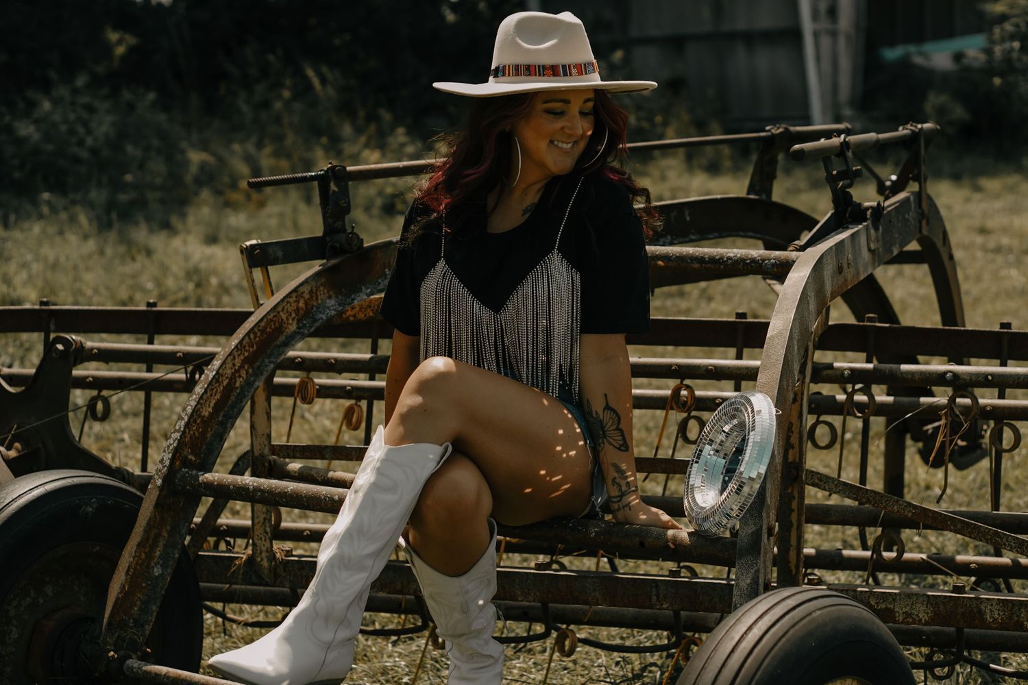 Western-style boots and hat create a rustic ranch scene on vintage wagon wheels.