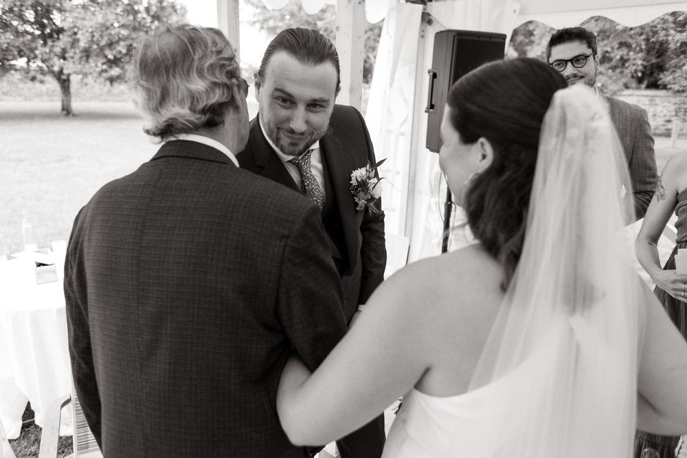 Black and white wedding ceremony photos showing tender moments between couples and guests during celebrations.