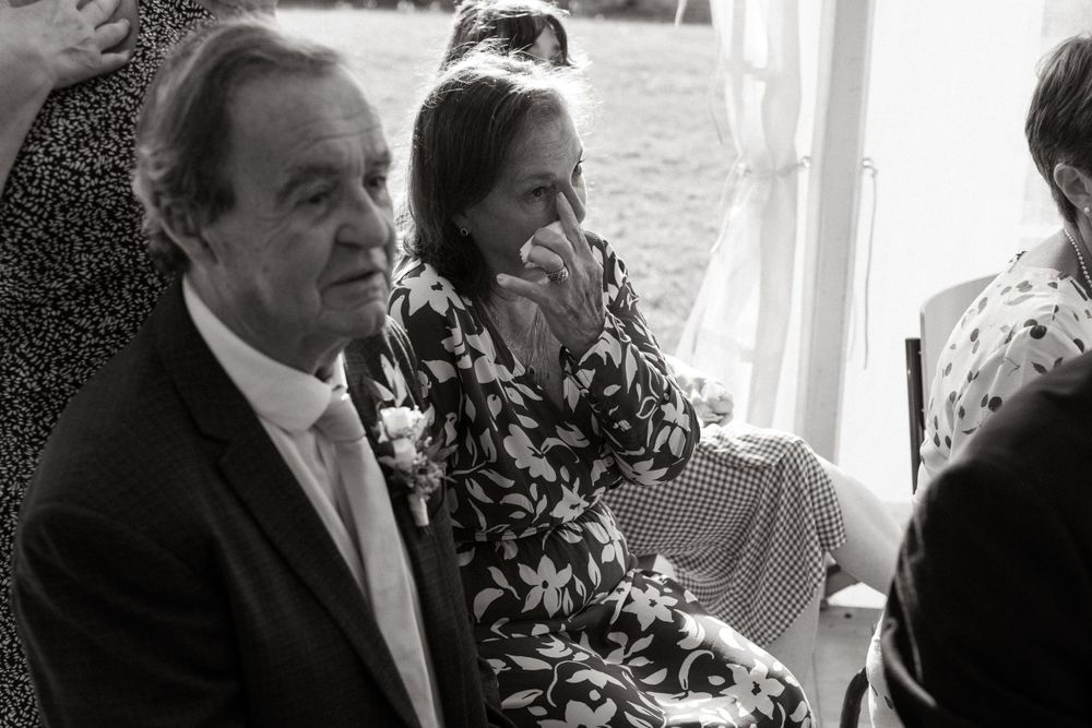 Wedding guests enjoying candid moments at an outdoor reception.