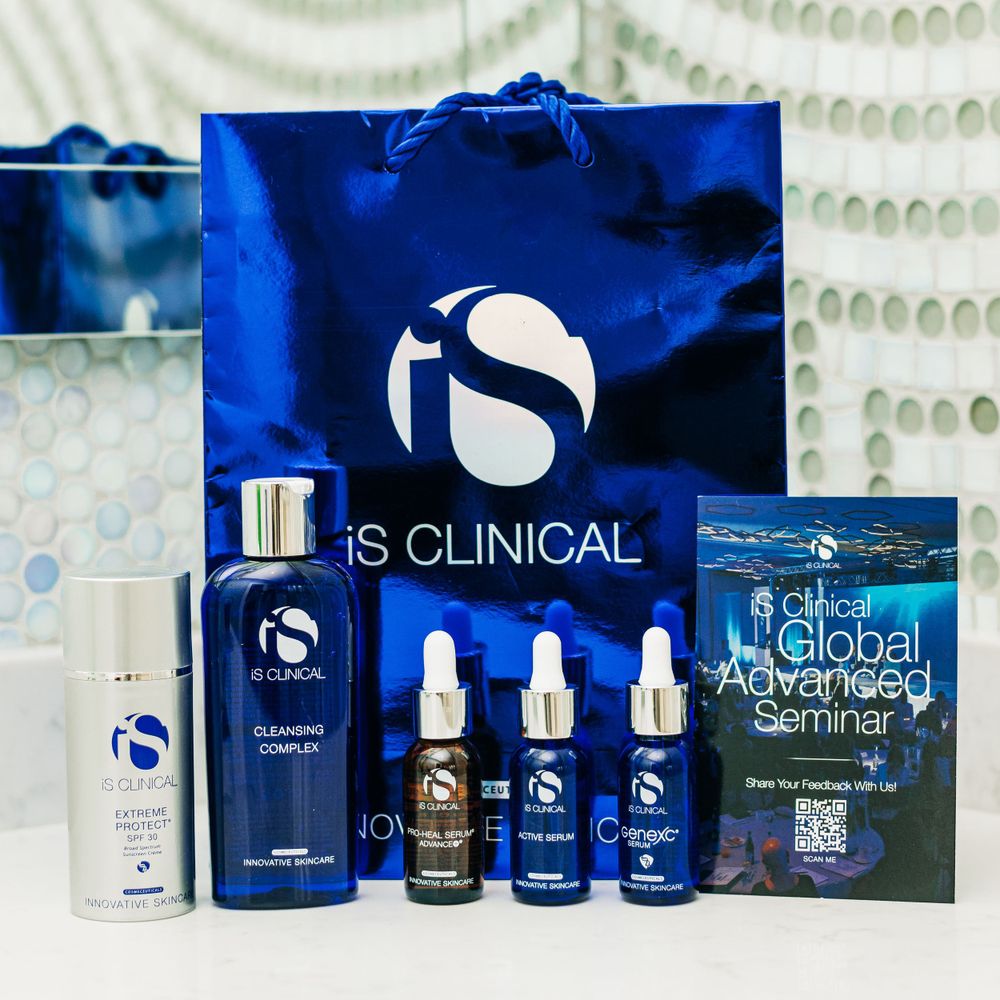Complete iS Clinical skincare kit with blue shopping bag and product literature.