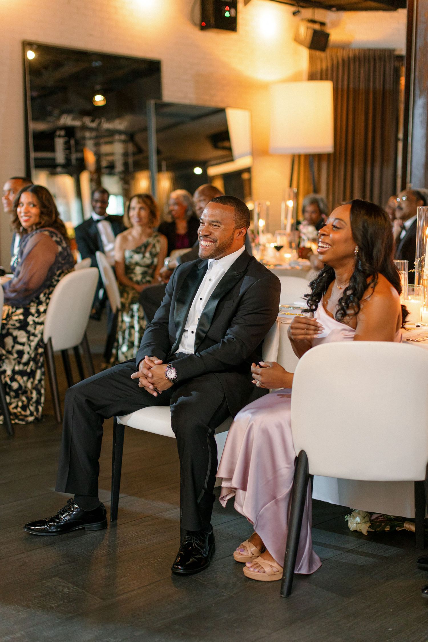 Wedding guests enjoying entertainment during reception in modern industrial venue.