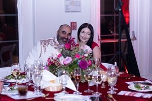 Elegant table setting with pink floral centerpiece and formal place settings at an upscale dinner event.