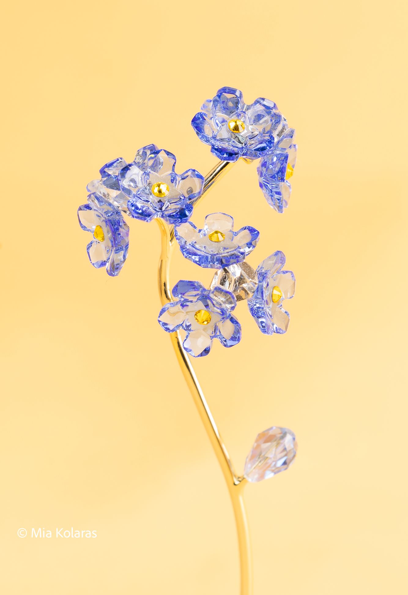 Crystal flower in front of a yellow and pink backdrop