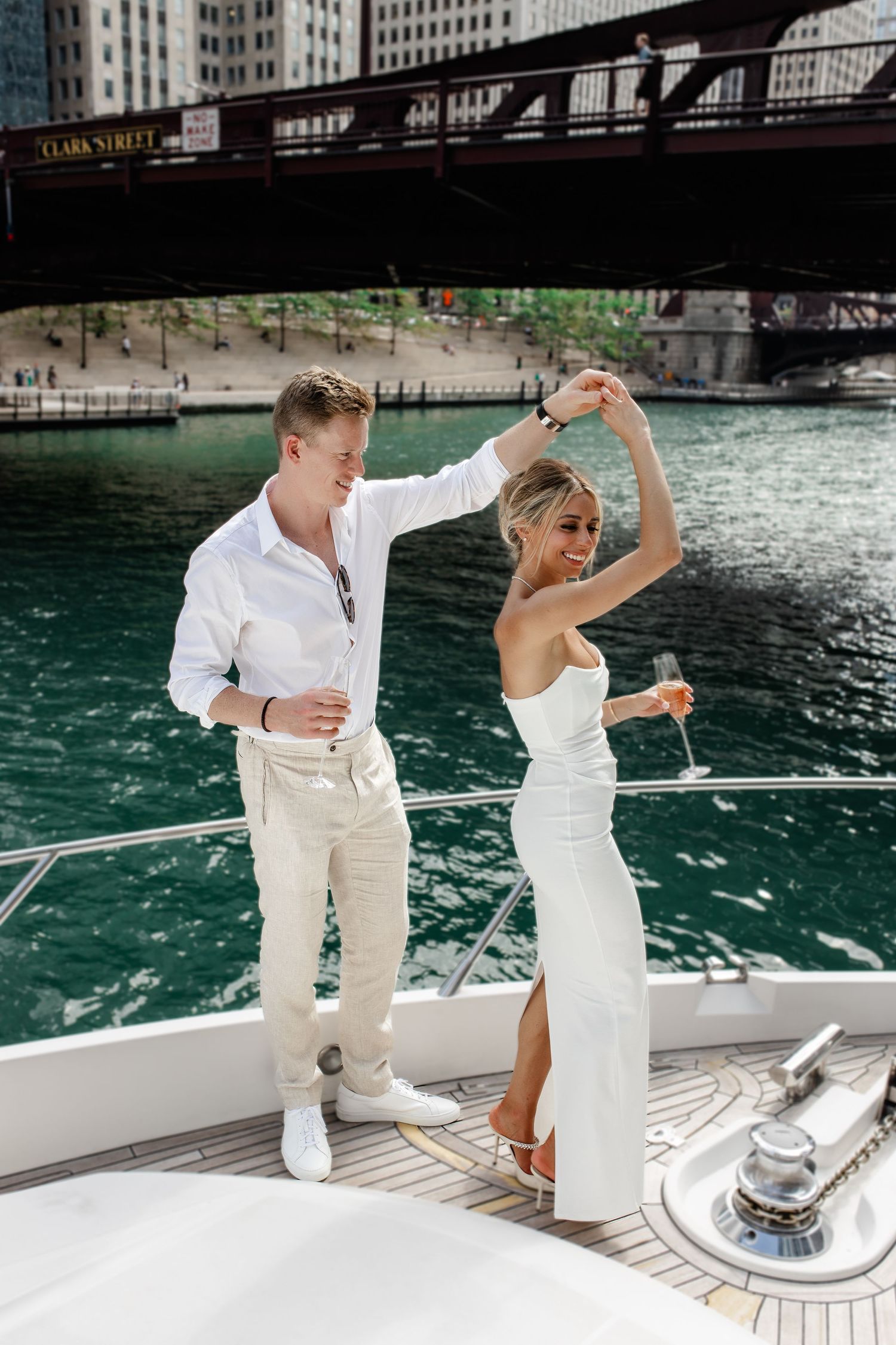 A romantic dance moment on a boat deck with Chicago's riverfront visible in the background.
