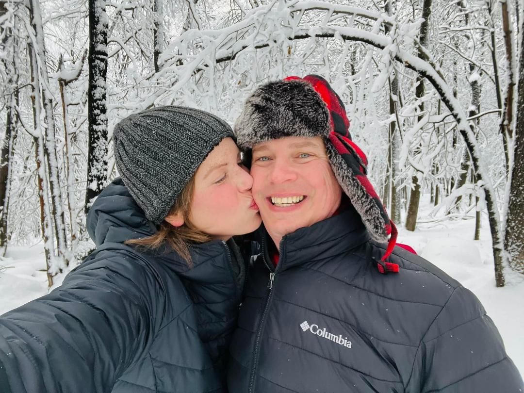 Photograph of a loving couple in the snow.  Blue Onion Photography.