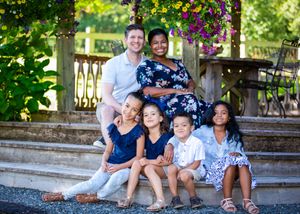 Family photo series with group sitting together on outdoor stone steps amid vibrant greenery.