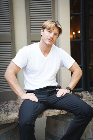 Nikolay Koltslov posing wearing a white t-shirt.