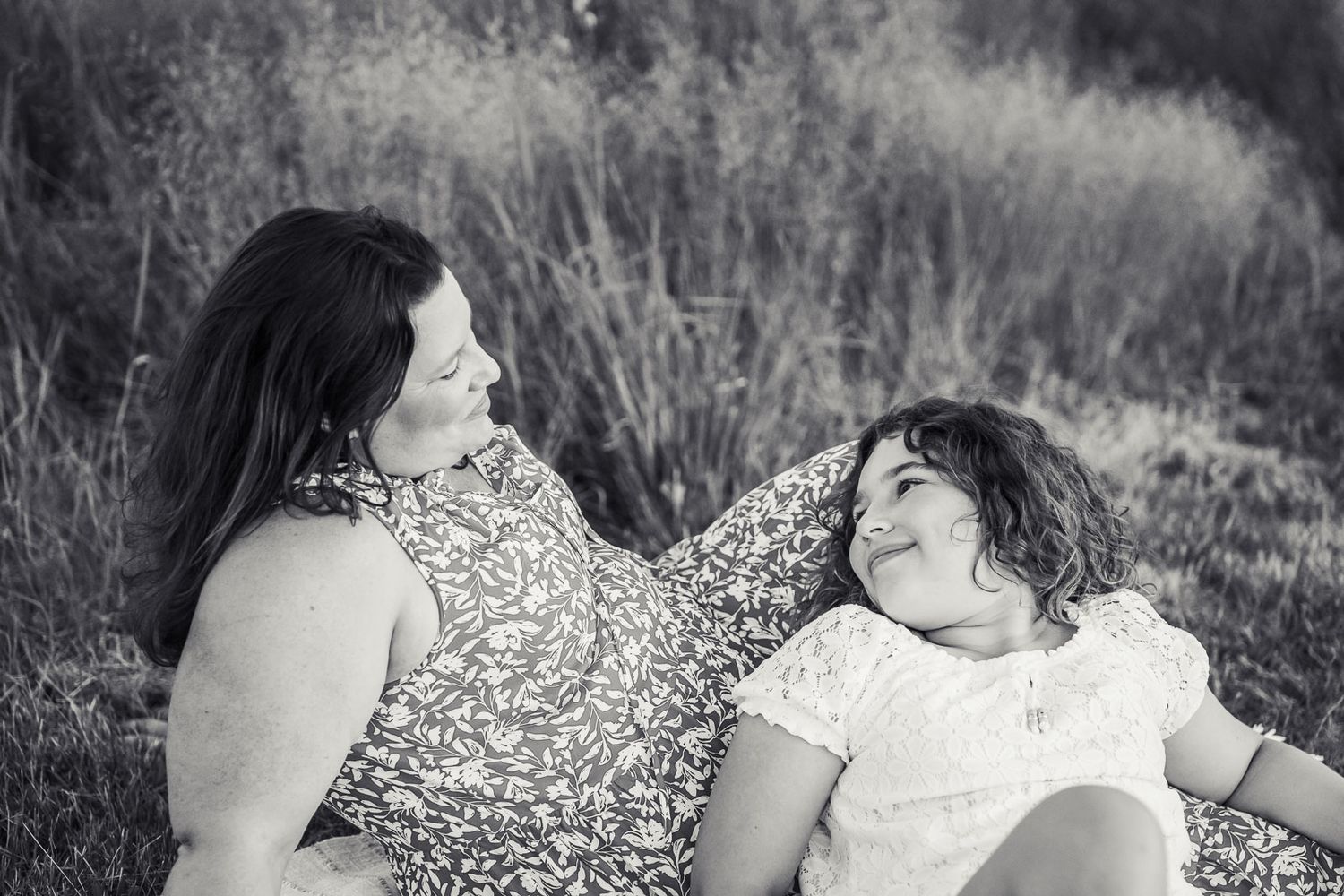 Daughter laying in mothers lap in Redmond