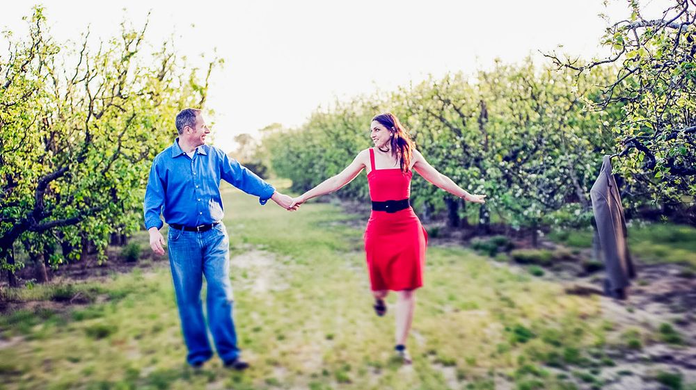 Portrait of an recently engaged couple in a natural orchard setting. Rural location on california's central Coast by Black Box Images