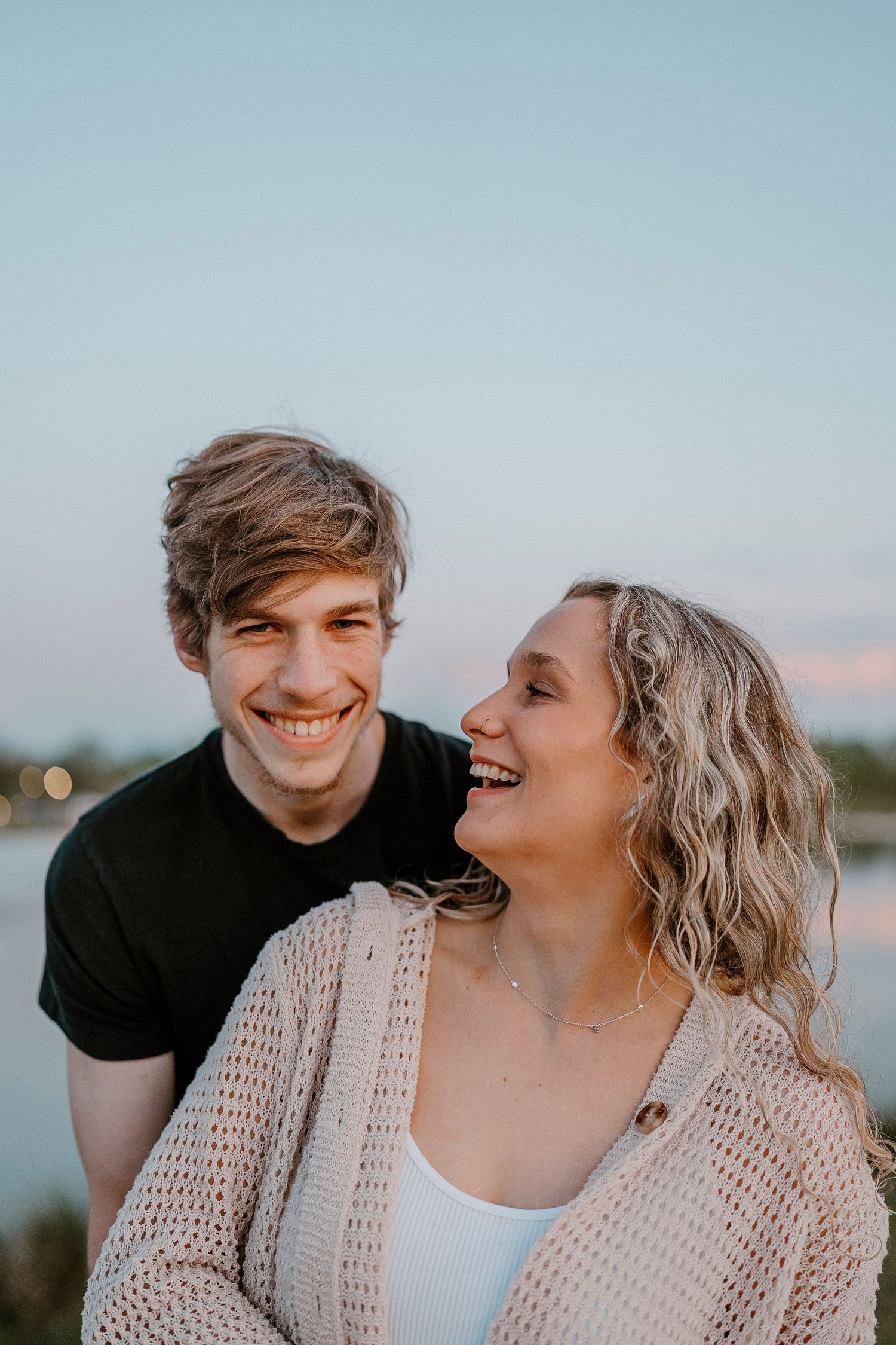 Candid moment of laughter and joy captured between couple in casual attire.