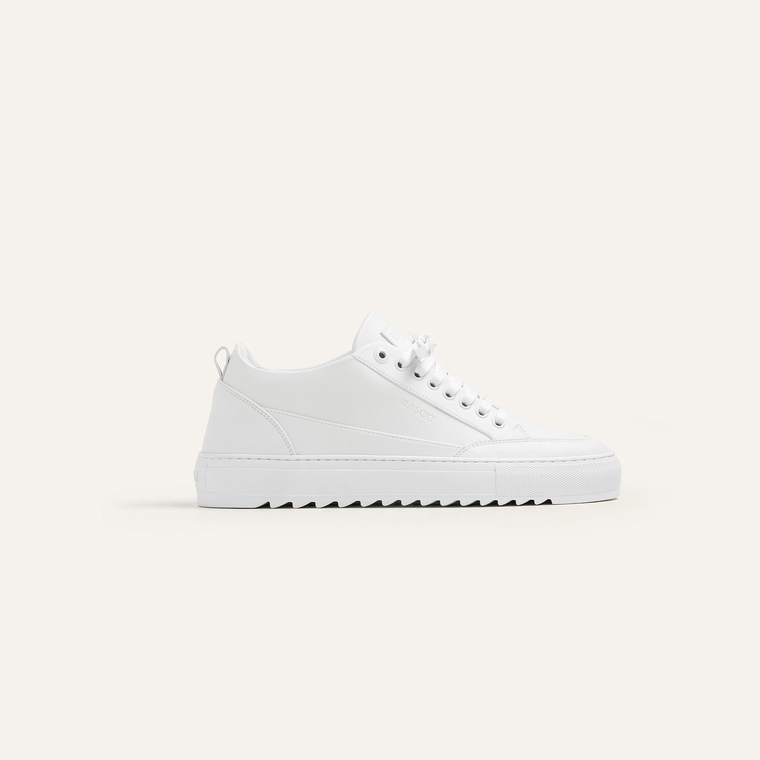 White canvas sneaker with rippled sole displayed from different views.