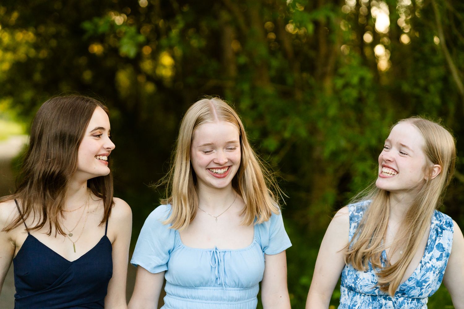 Teenage daughters laugh and walk at the Union Bay Natural Area.
