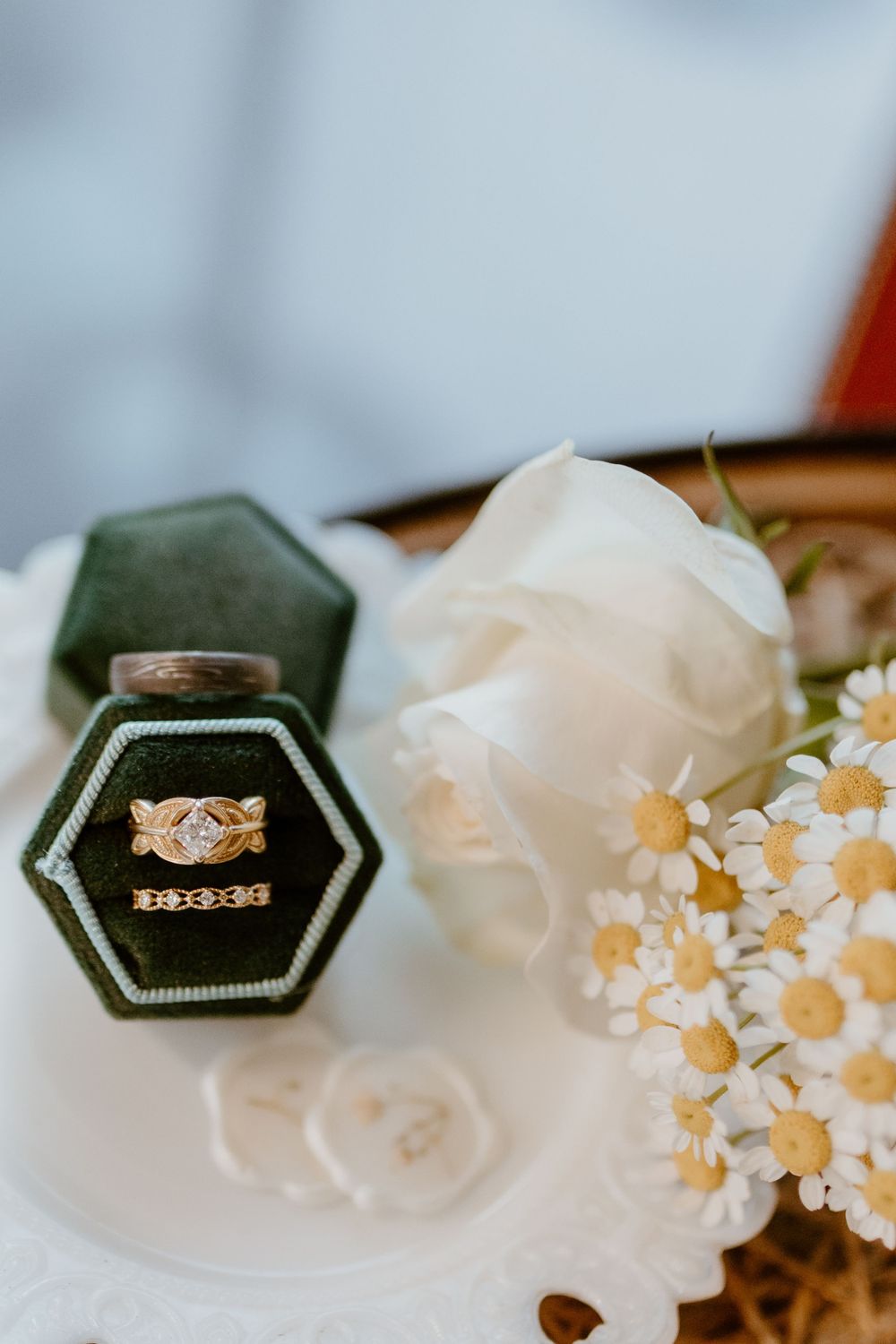 Elegant wedding details featuring vintage-style hexagonal ring box with flowers.