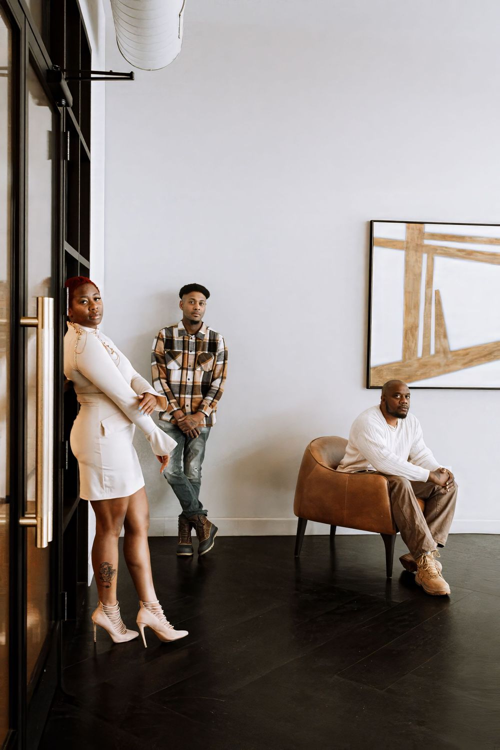 Modern studio photoshoot with white boots and vintage furniture against minimalist backdrop.