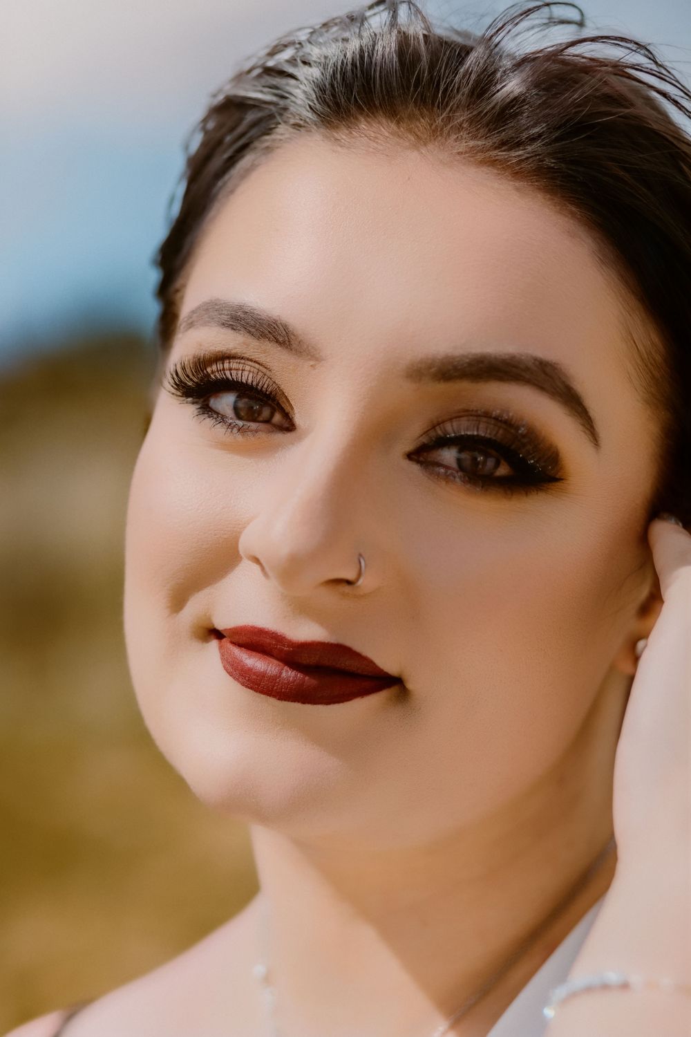 Beautiful bridal makeup details featuring dark red lipstick and dramatic eye makeup in close-up shots.