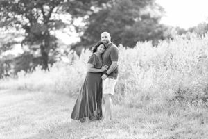 Black and white romantic portrait of a couple in a sunny meadow.