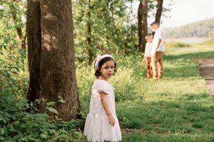A couple stands together in a sunny garden setting during a romantic outdoor wedding ceremony.