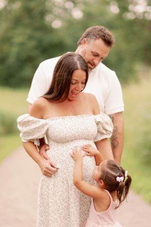 Family sharing tender moment together on outdoor path.