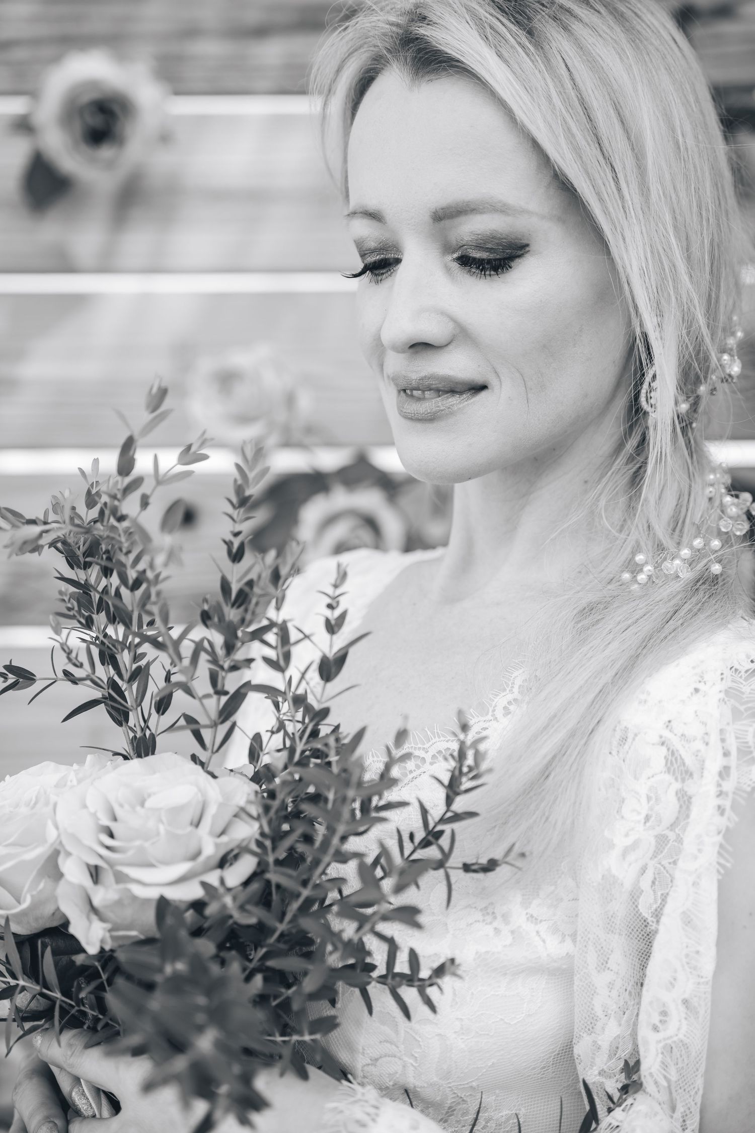 Classic black and white bridal portrait with delicate floral bouquet.