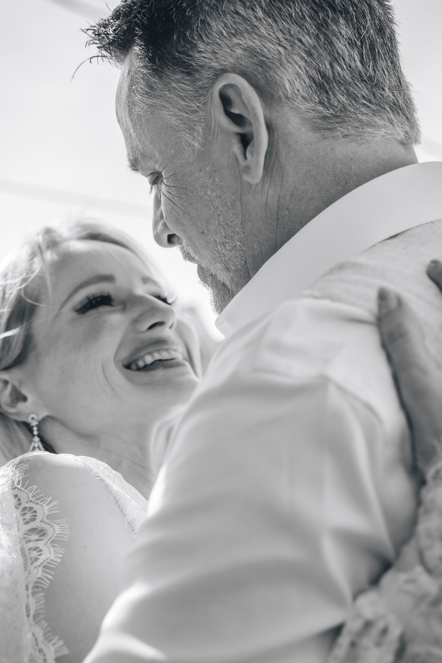 Intimate black and white wedding photo capturing romantic dance moment.