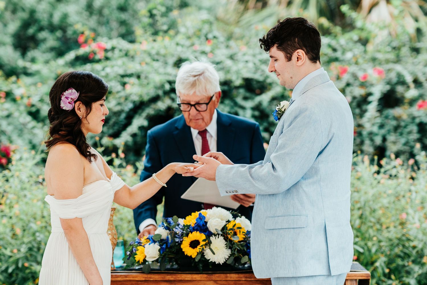 Wedding ceremony in a garden with exchange of rings.