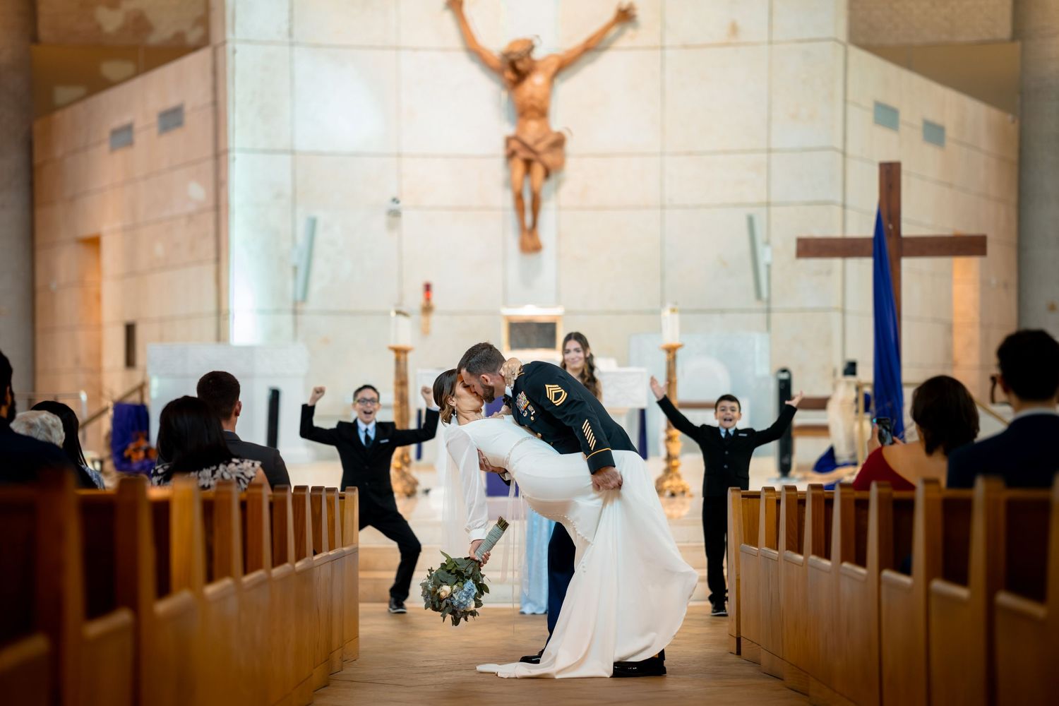 Joyful wedding ceremony in church with couple dancing down aisle as guests celebrate.