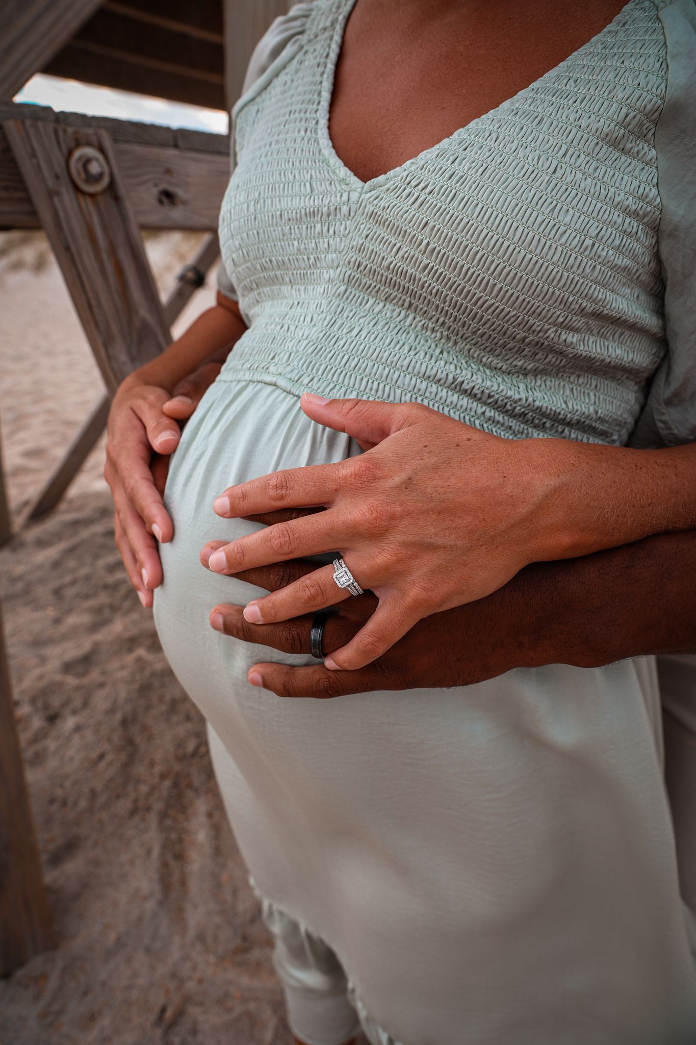 Close-up maternity photography sequence showing pregnant belly in soft mint green top.
