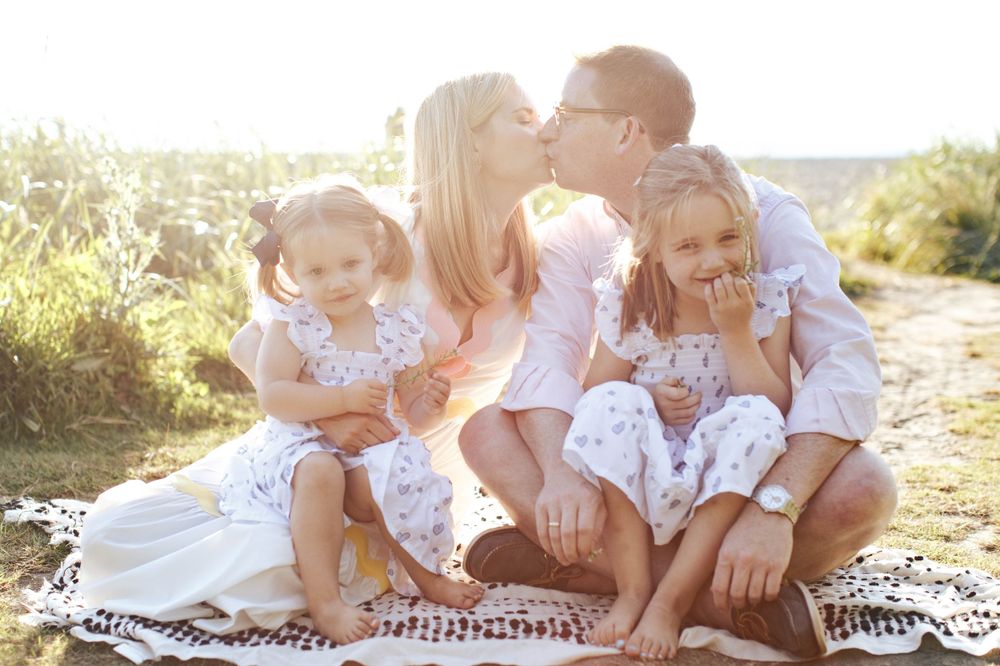 Seattle outdoor family photographer: a mom, dad and two daughters at carkeek park Seattle