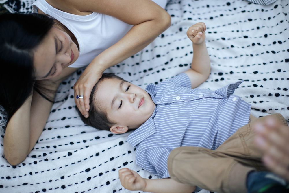 seattle family photographer: a mother and son laying on a blanket at Washington park arboretum in seattle