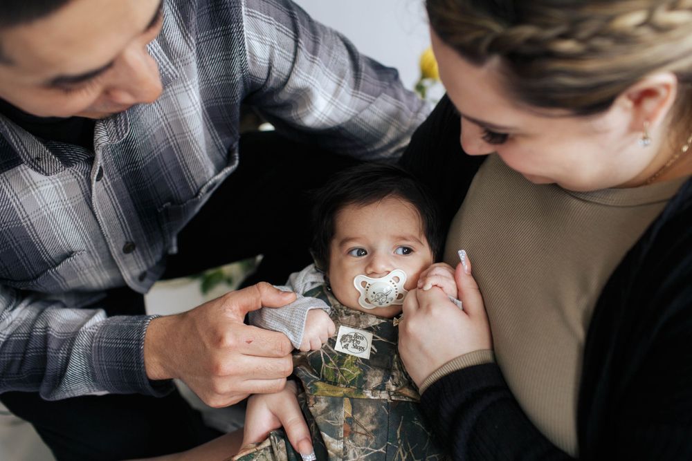everett family photographer: a mother and father with their newborn son at an in home family photo session