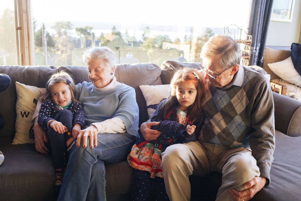 mukilteo family photographer: a grandmother and grandfather with two young grandkids at home in mukilteo