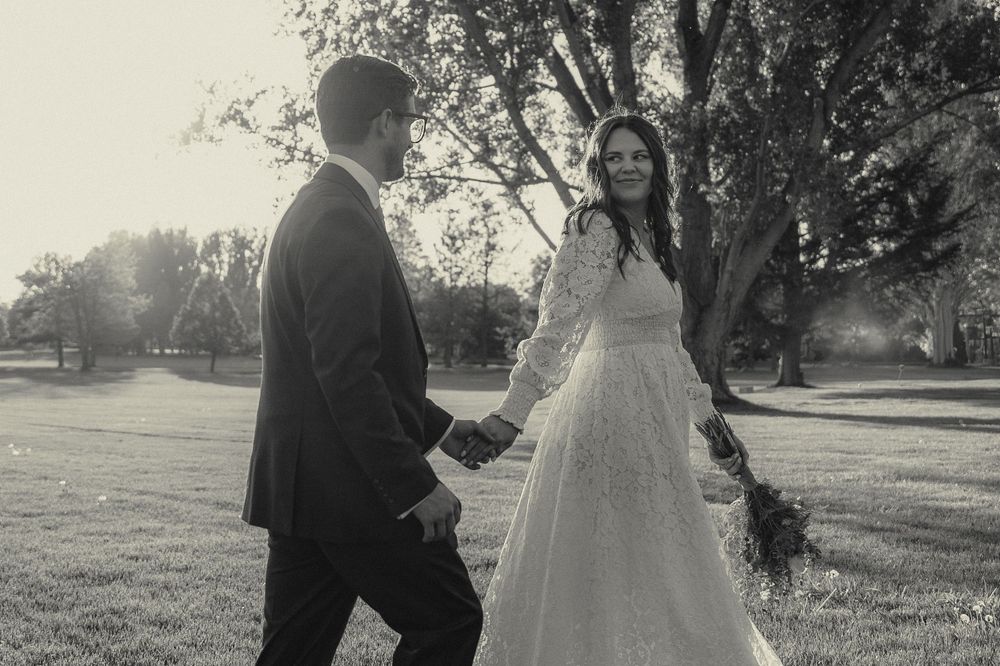 Logan UT wedding couple enjoying their bridals. They are walking hand in hand and looking at each other for their portraits.