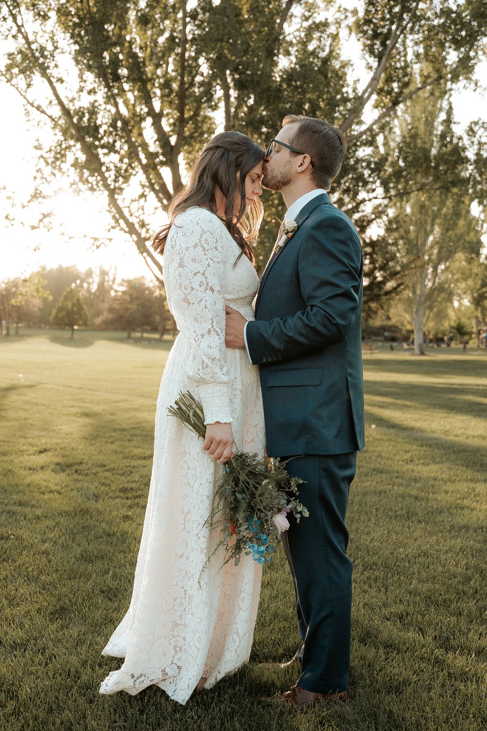 Wedding couple kissing and embracing for their wedding day in Cache Valley with a local photographer.