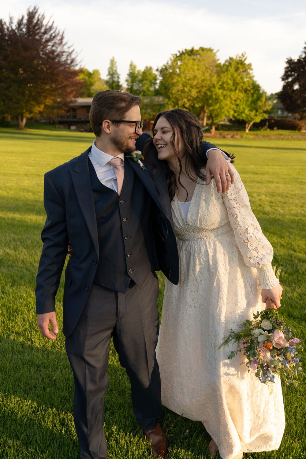 Wedding couple having fun during their Logan, UT wedding making each other laugh and smile during a golden hour evening.