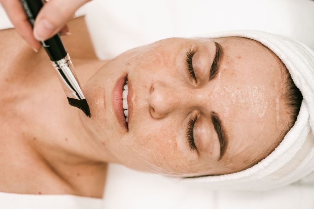 A close-up promotional photo series showing skincare and beauty treatments with white towels.